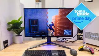 LG Ultra Gear 27GR95QE on desk with keyboard, mouse and game controller with Tom's Guide Prime Day badge