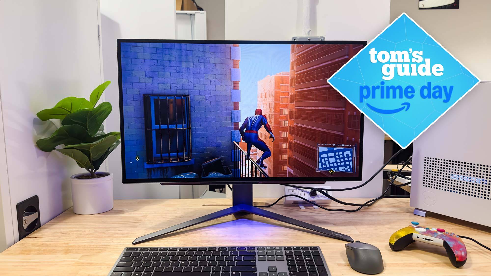 LG Ultra Gear 27GR95QE on desk with keyboard, mouse and game controller with Tom's Guide Prime Day badge