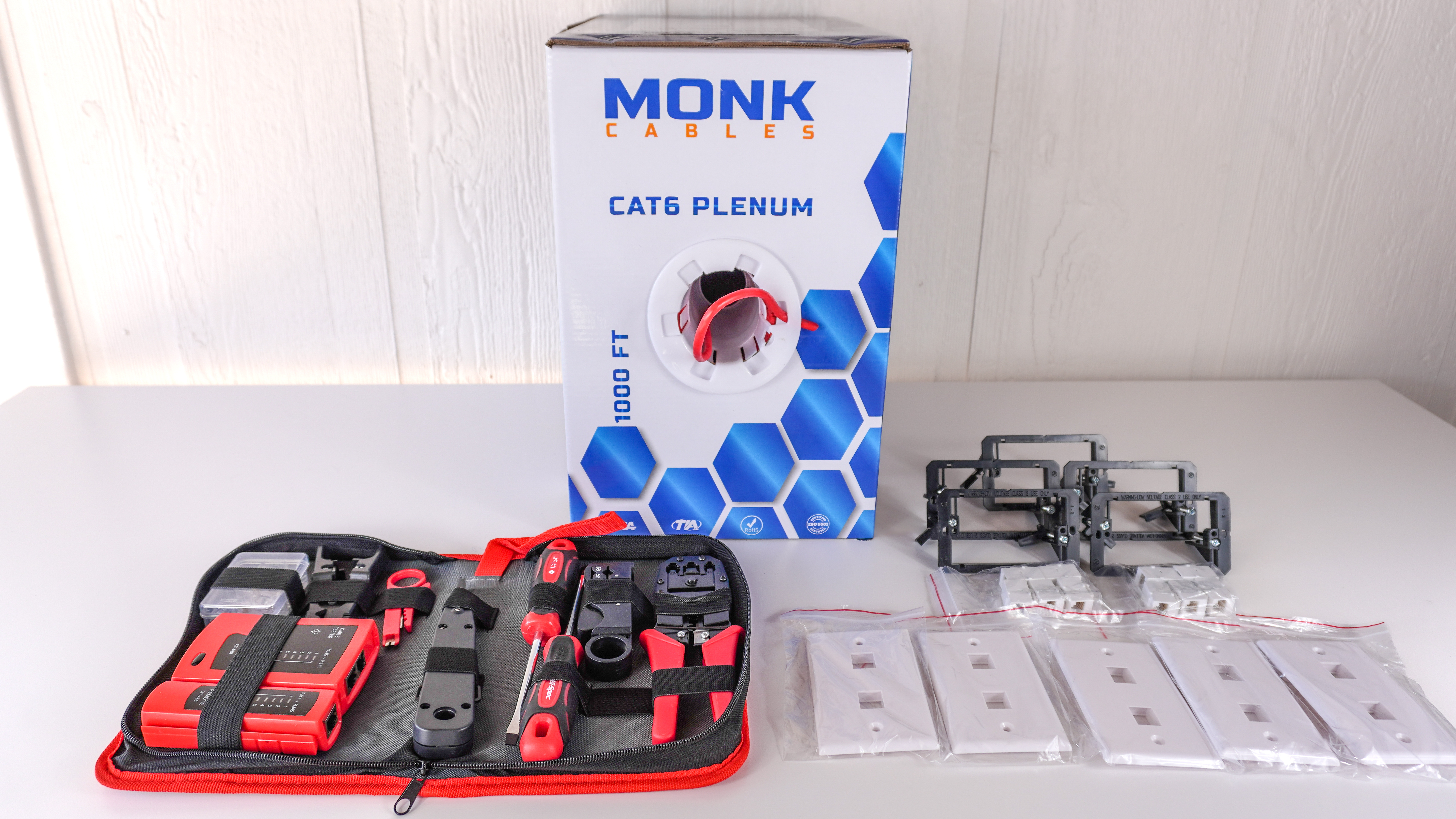 All of the tools and supplies needed to wire a house for Ethernet spread out on a table