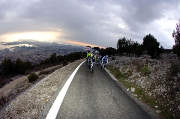 Riders make their way up Mont Faron as the sun sets over Toulon
