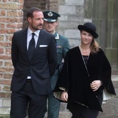 Crown Prince Haakon and Princess Martha Louise walking in black outfits