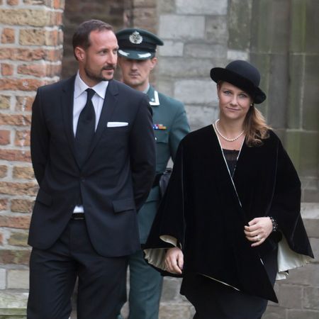 Crown Prince Haakon and Princess Martha Louise walking in black outfits