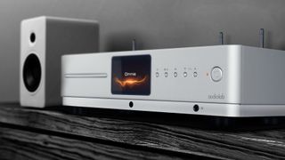 Audiolab Omnia all-in-one system next to a speaker