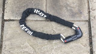 A Zefal K-Traz M12 Code chain lock on paving stones