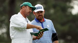 Louis Oosthuizen in discussion with his caddie at The Masters