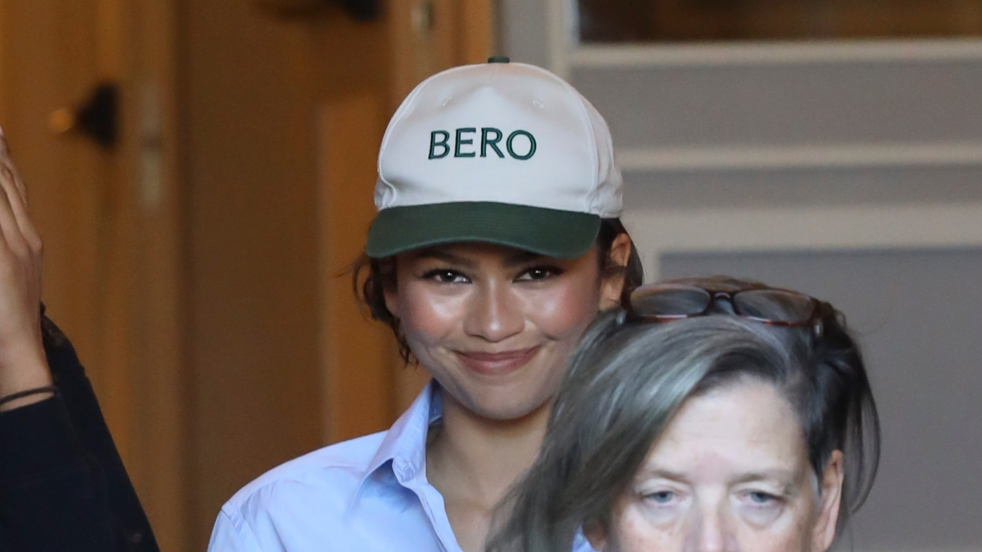 Zendaya wearing a Bero cap, referencing rumored husband Tom Holland's brand during a shopping trip in Rome, Italy, paired with cuffed jeans, a shirt, and The Row loafers