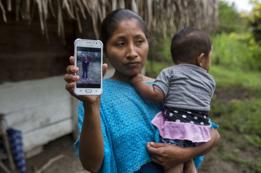 Claudia Maquin, 27, shows a photo of her daughter, Jakelin Amei Rosmery Caal Maquin in Raxruha, Guatemala, on Saturday, Dec. 15, 2018. 