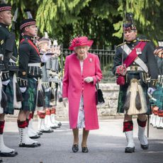 Queen Elizabeth II inspects soldiers from the Royal Regiment of Scotland