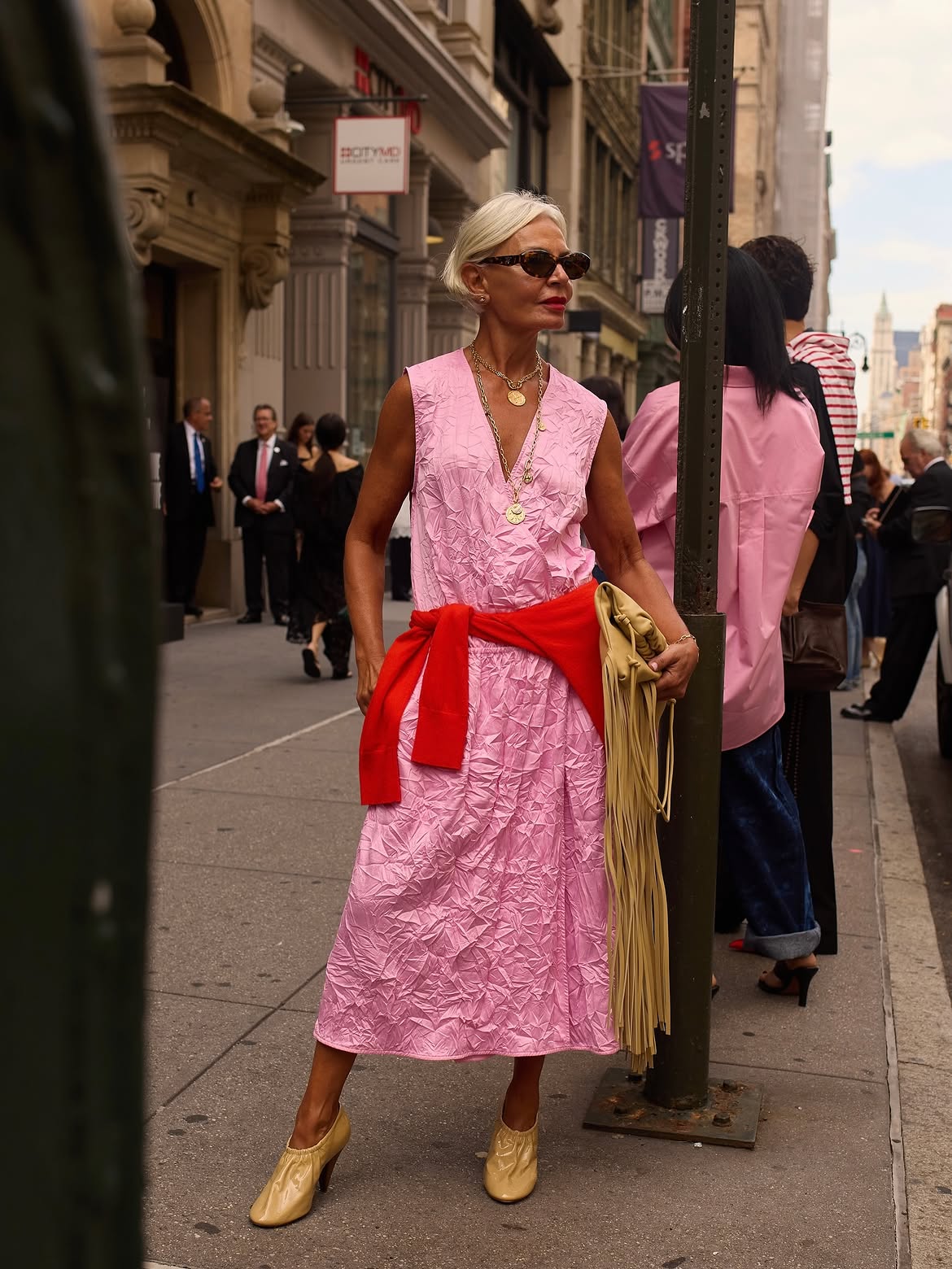 @greceghanem wears pink dress red jumper