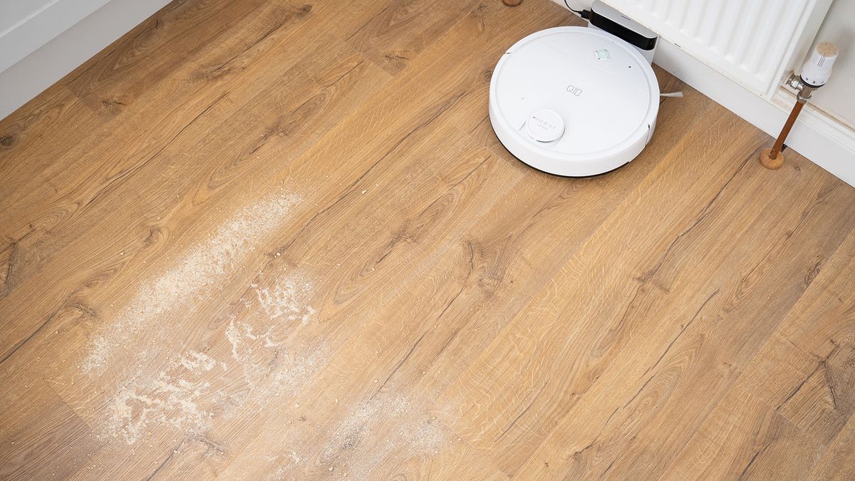 Crumbs on wooden floor before suction test