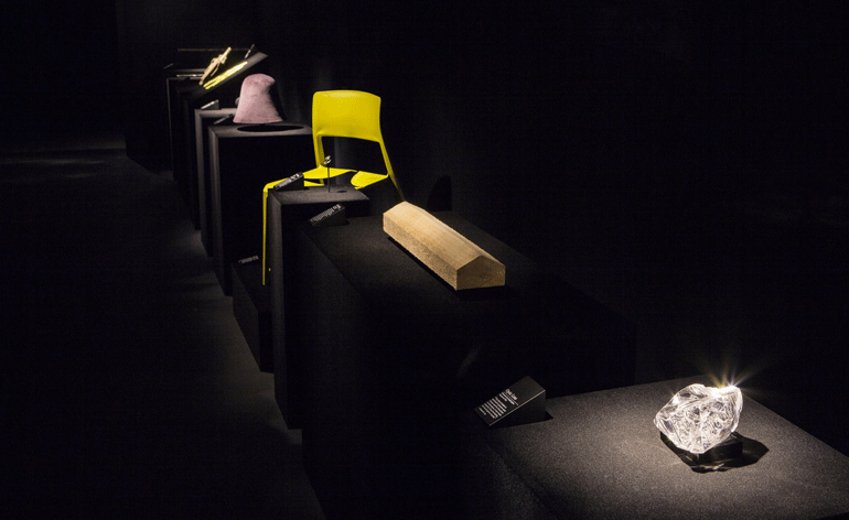 Tip Ton Chair (centre) - stands alone, spotlit on a plinth