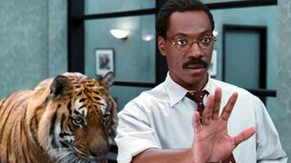 A still from Doctor Dolittle, one of December's new Hulu movies, showing Eddie Murphy as Doctor Dolittle with a big tiger behind him