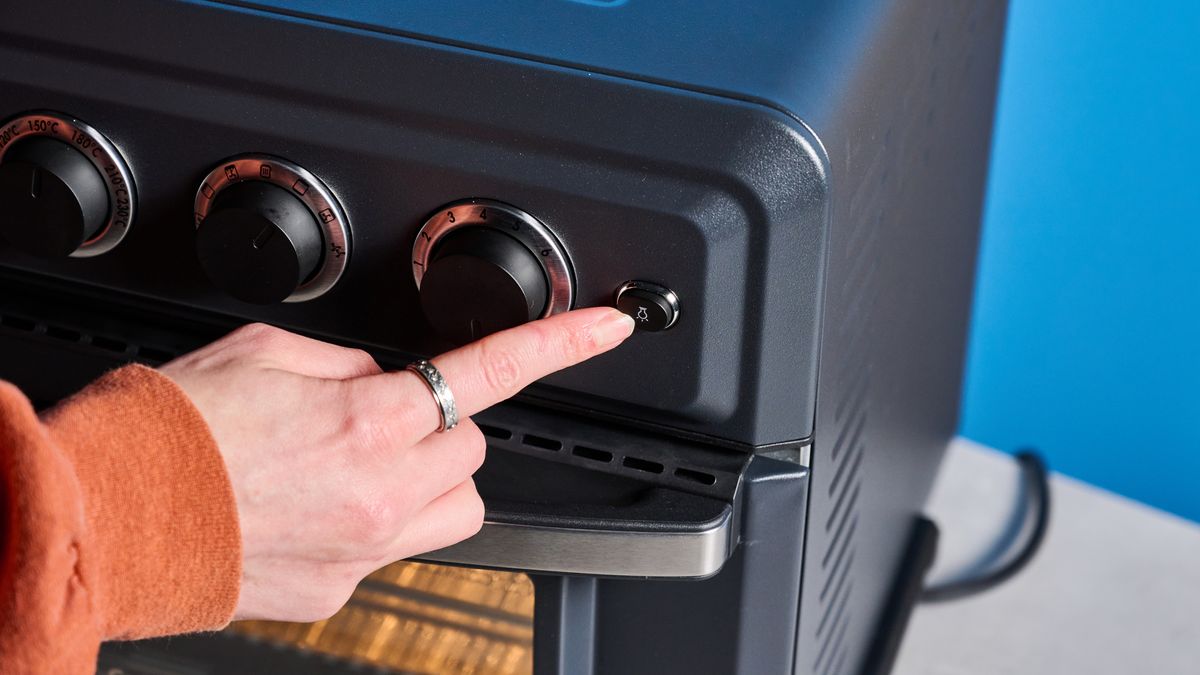 the cuisinart air fryer and toaster oven toa-60 with a black exterior, four temperature and timer dials