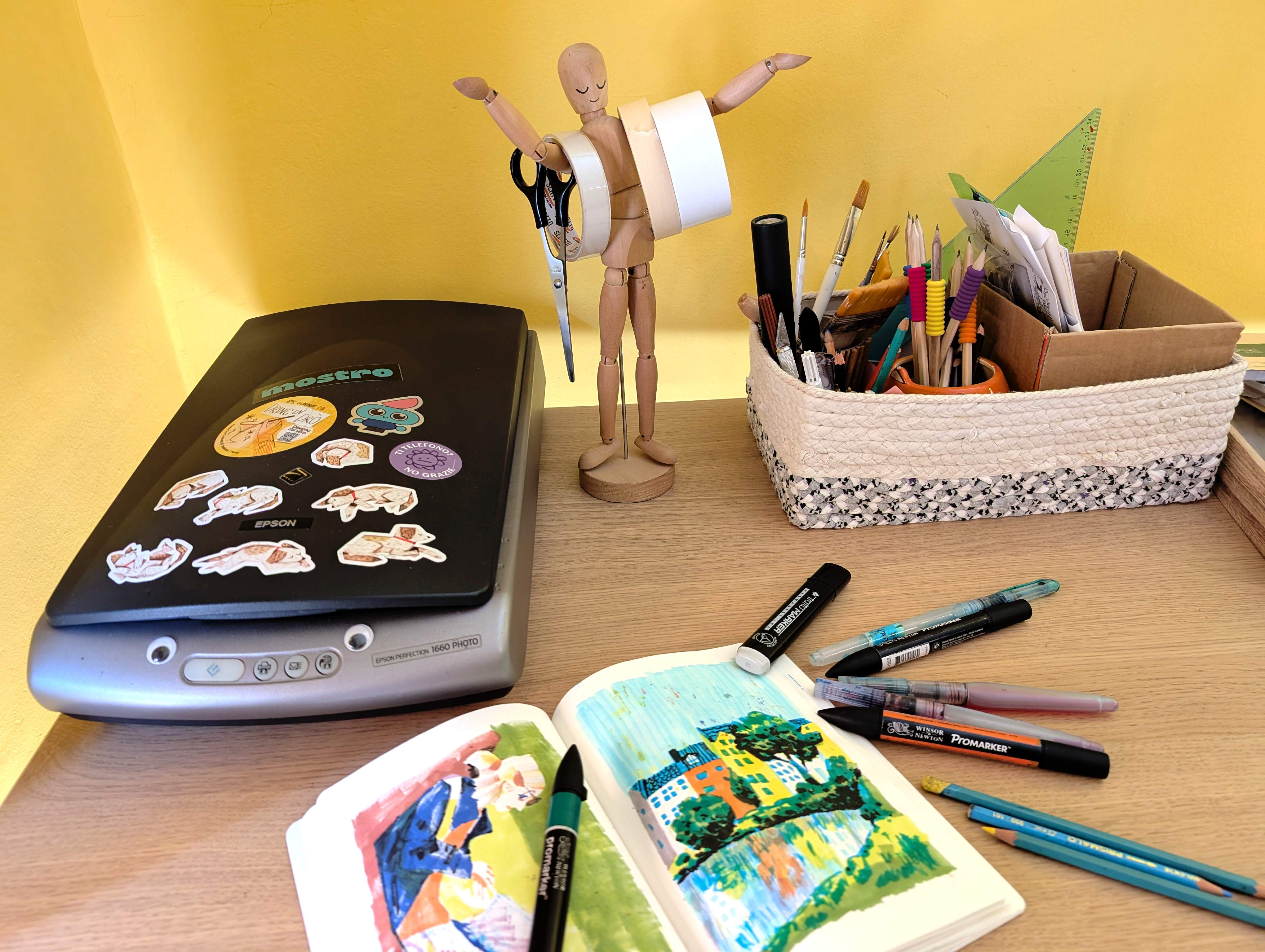 Artist sketchbook; art supplies on a desk