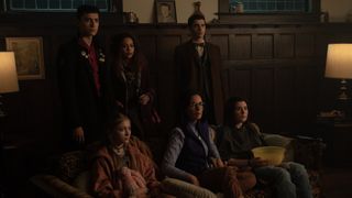The Dead Boy Detectives standing behind the Devlin family in the home in Dead Boy Detectives episode 3.