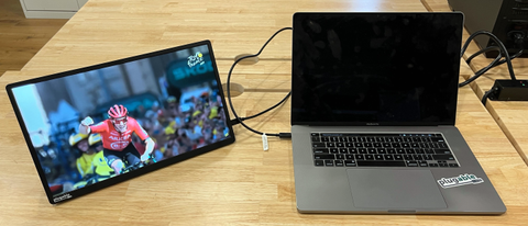 The Plugable 15.6” USB-C Portable Display (USBC-PDMON) sitting on a table connected to a MacBook Pro.