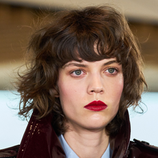 Model wearing red blush and red lipstick