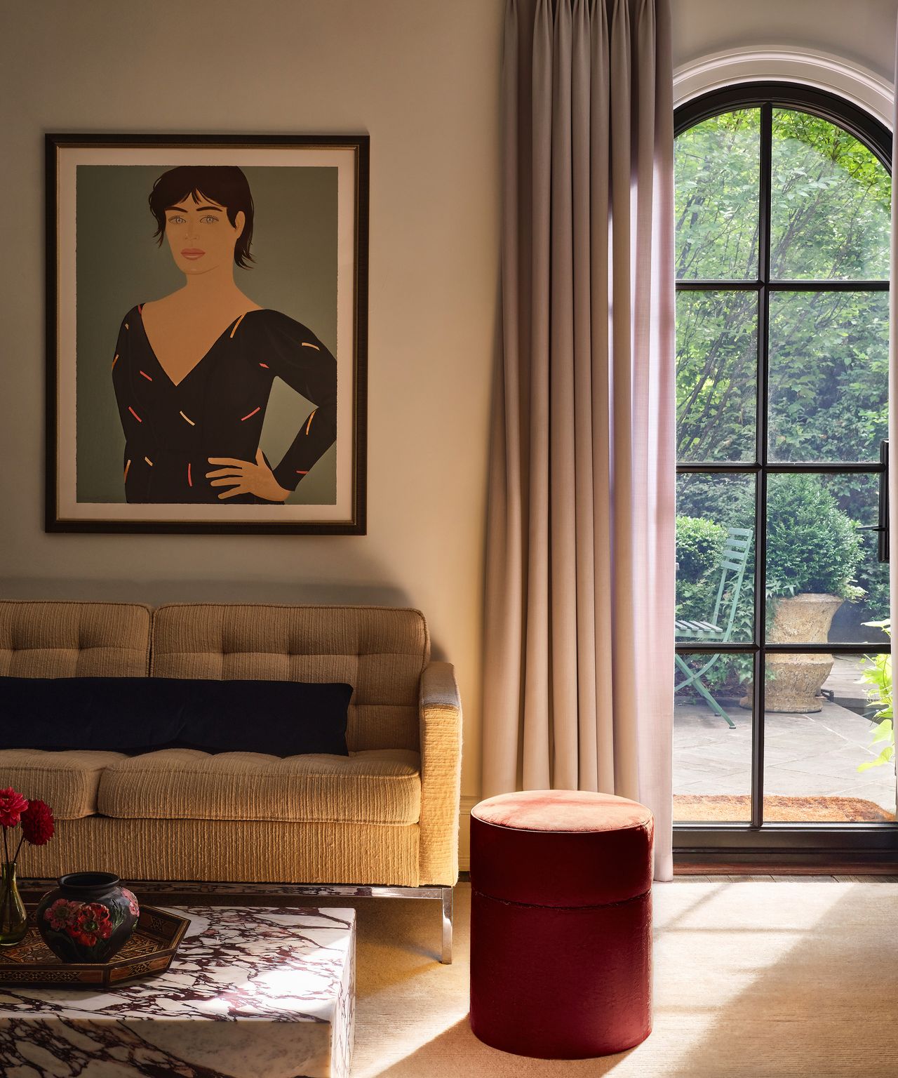 living room with gray curtain at the window and sunlight filtering in