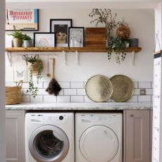 Laundry room with metro tiling, marble worktops and styled shelving