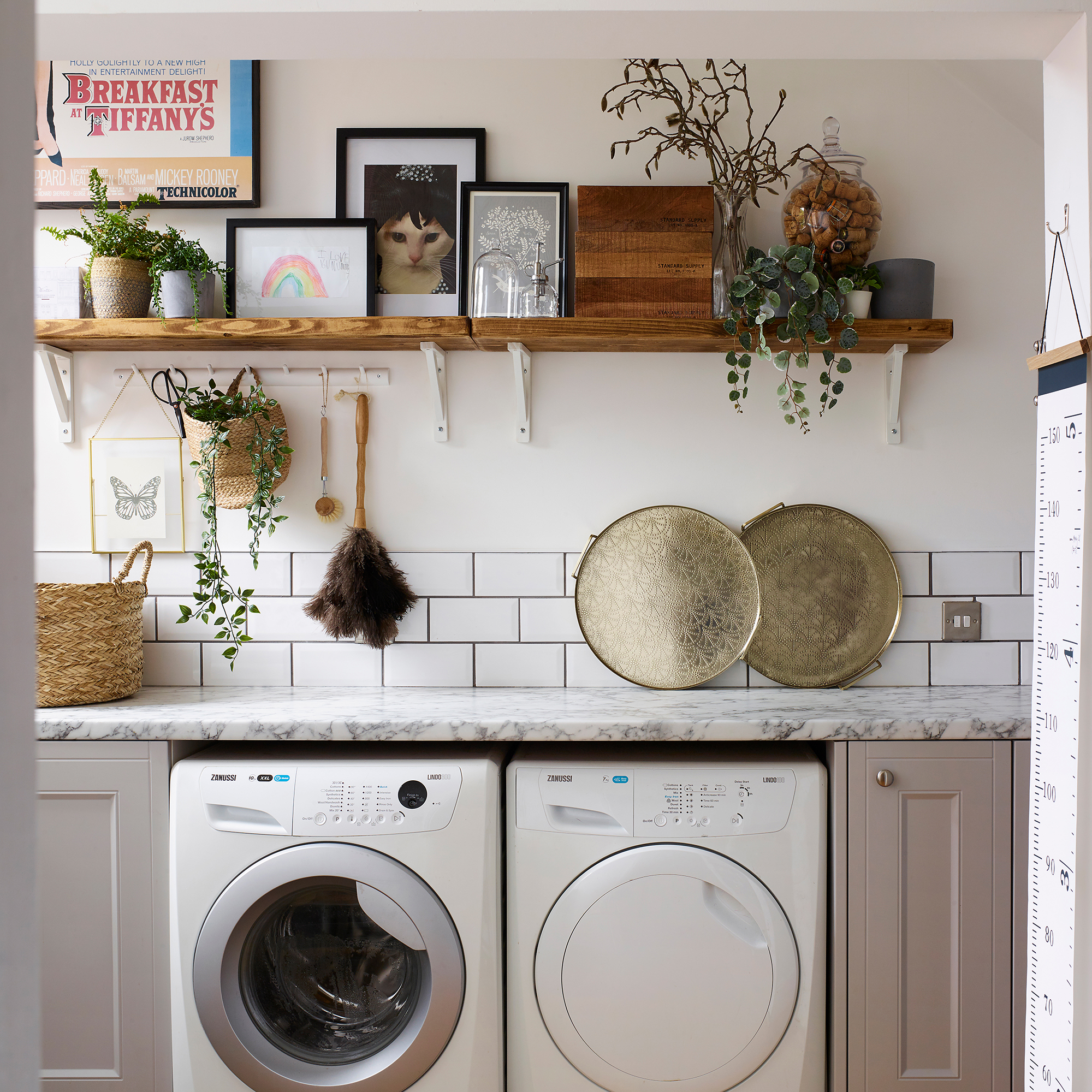 Laundry room with metro tiling, marble worktops and styled shelving