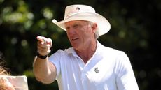 Greg Norman pictures walking at Augusta National during day two of The 2024 Masters