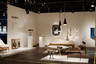 Modern furniture including tables, sofa and accessories displayed in a gallery