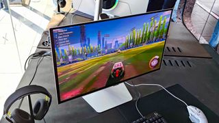Samsung Odyssey OLED G6 with Rocket League on screen sitting on desk next to window