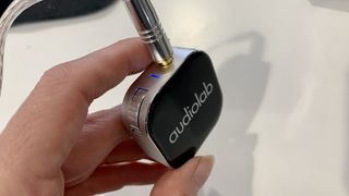 Audiolab M-DAC Nano held in a hand