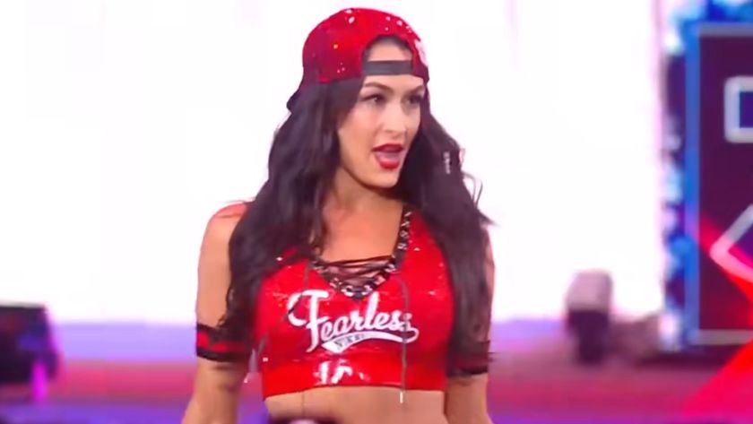 Nikki Bella making her entrance in the 2025 Royal Rumble wearing her signature &quot;Fearless&quot; top and a red ball cap. 