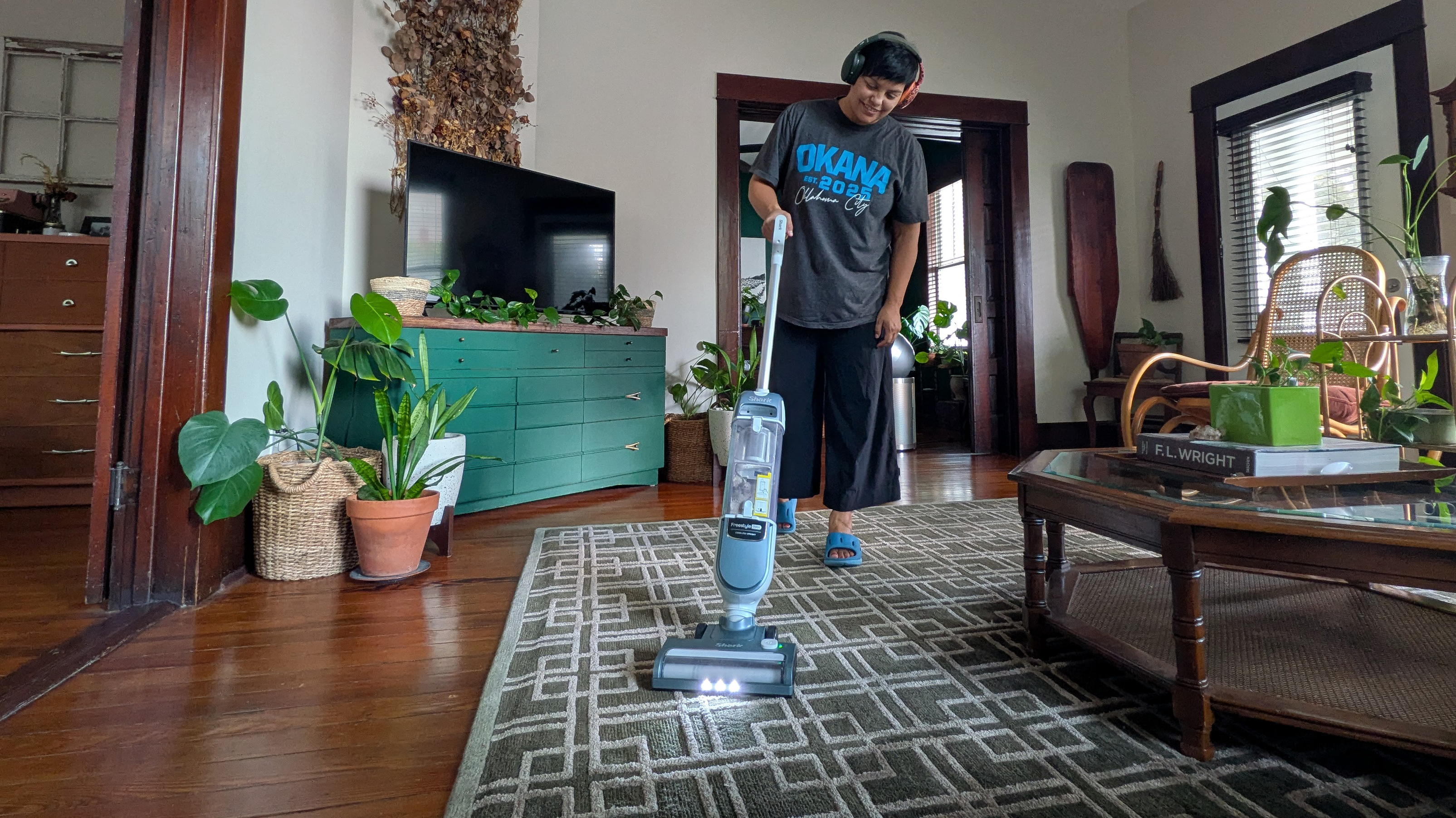 Tester using the Shark Freestyle Max cordless upright vacuum in her home