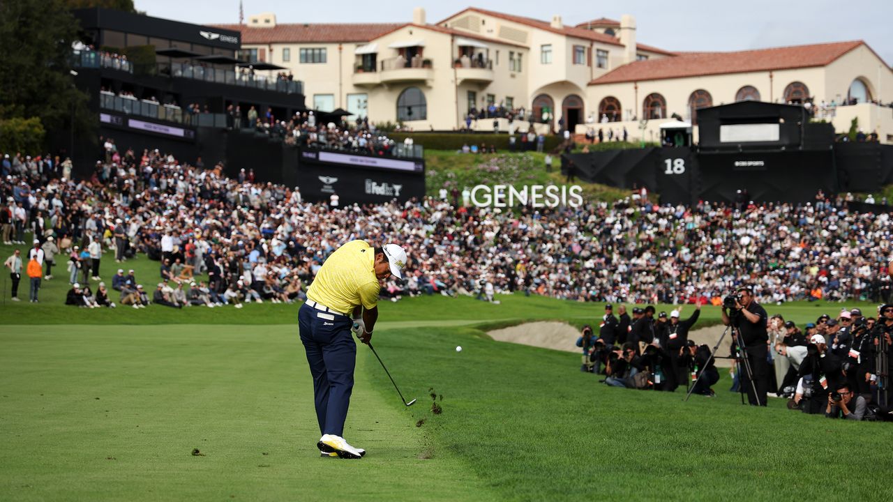 Hideki Matsuyama hits an iron shot into the 18th hole during the Genesis Invitational