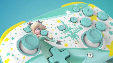 Image of the Rosalina Turtle Beach Rematch controller with a matching blue-green background.