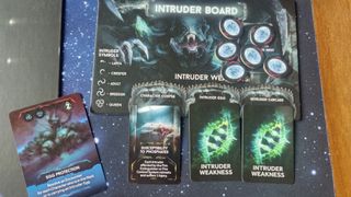 Nemesis board game Intruder board, tokens, and cards laid out on a starry backdrop