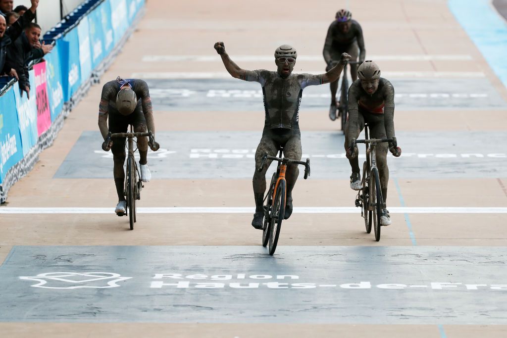 ROUBAIX FRANCE OCTOBER 03 Sonny Colbrelli of Italy and Team Bahrain Victorious covered in mud celebrates winning ahead of Florian Vermeersch of Belgium and Team Lotto Soudal and Mathieu Van Der Poel of Netherlands and Team AlpecinFenix in the Roubaix Velodrome Vlodrome Andr Ptrieux during the 118th ParisRoubaix 2021 Mens Eilte a 2577km race from Compigne to Roubaix ParisRoubaix on October 03 2021 in Roubaix France Photo by Bas CzerwinskiGetty Images