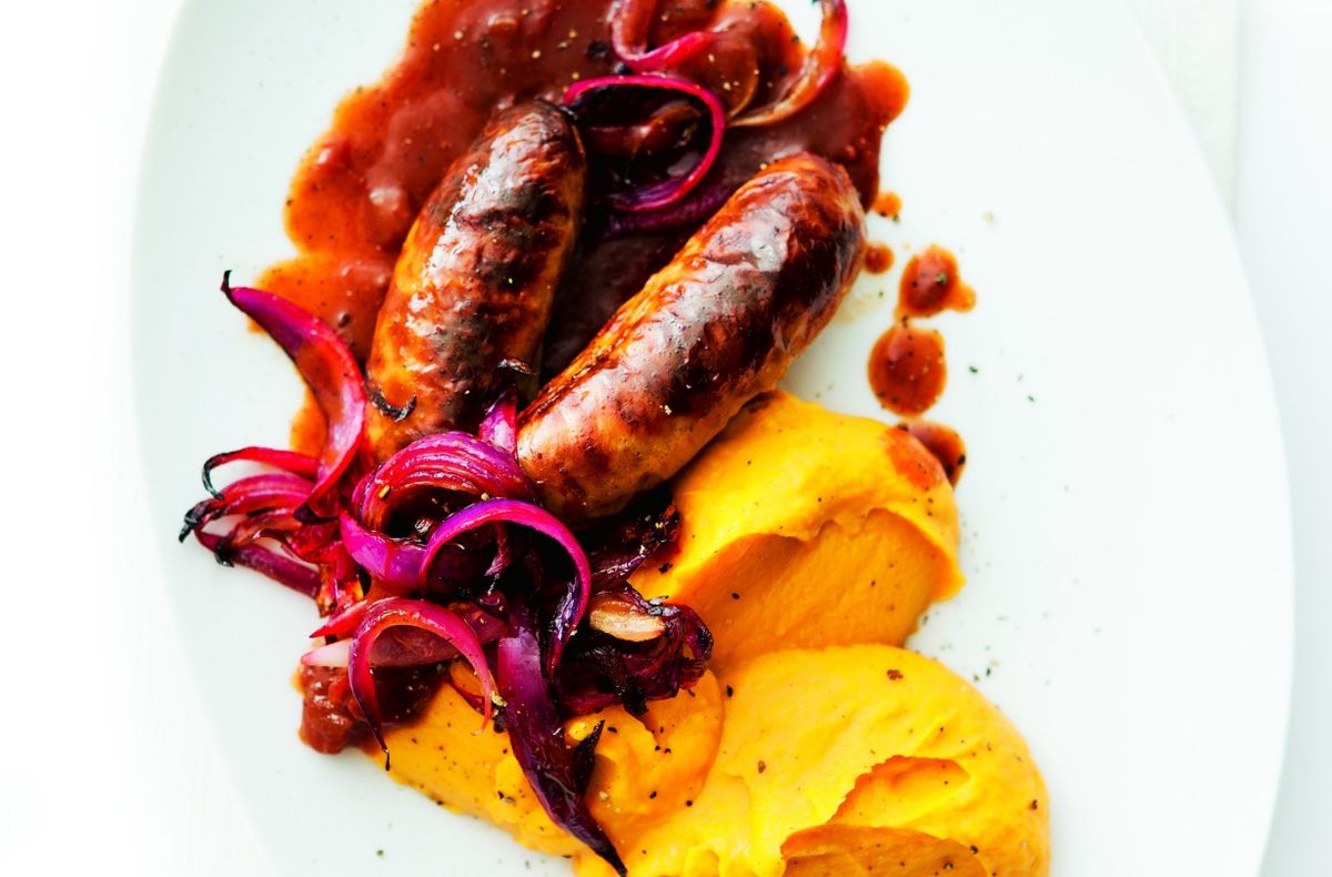 Sweet potato mash with sausages and red onion gravy British Recipes