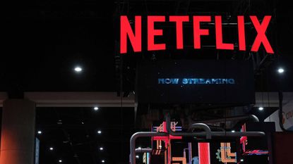 Red Netflix sign on set with Now Streaming written beneath it in blue