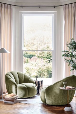 living room with green swivel chairs and parquet flooring