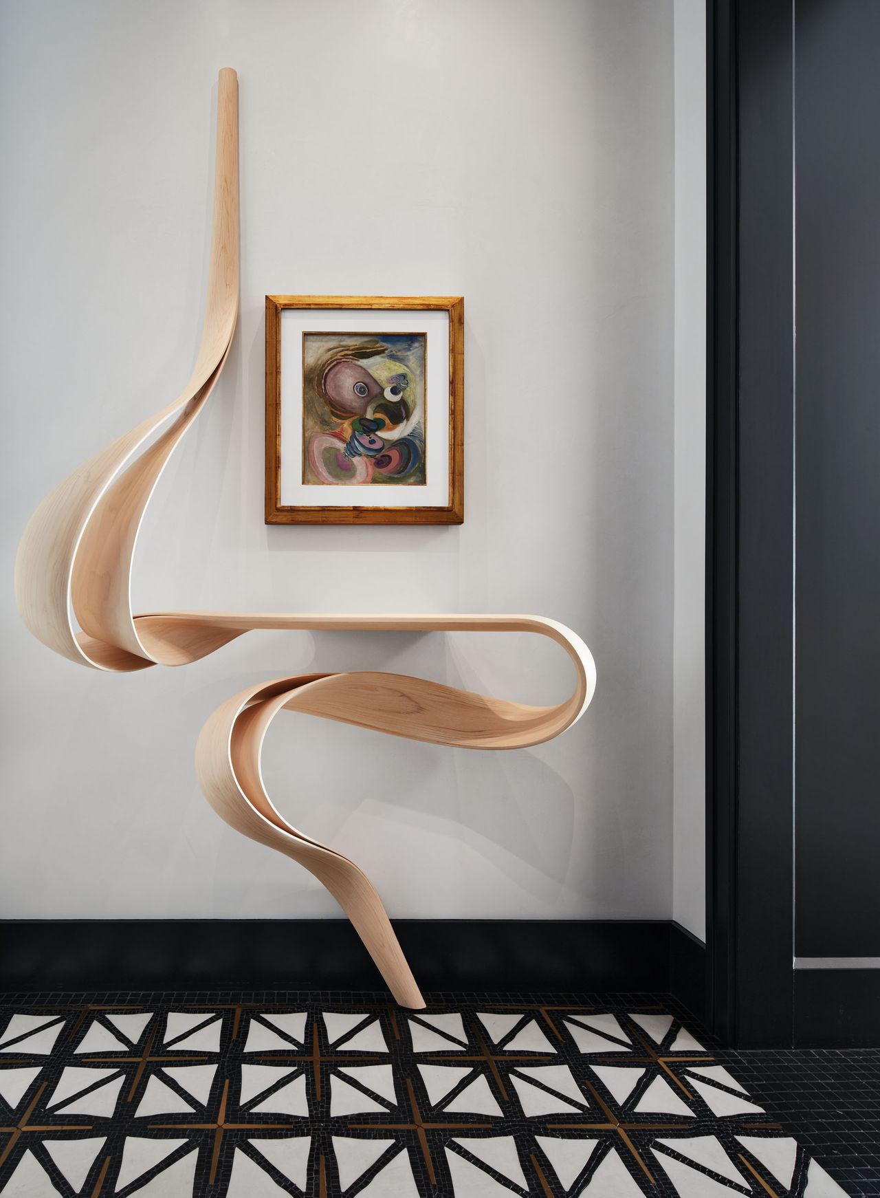 Wooden sculpture, black, white and brown tiles