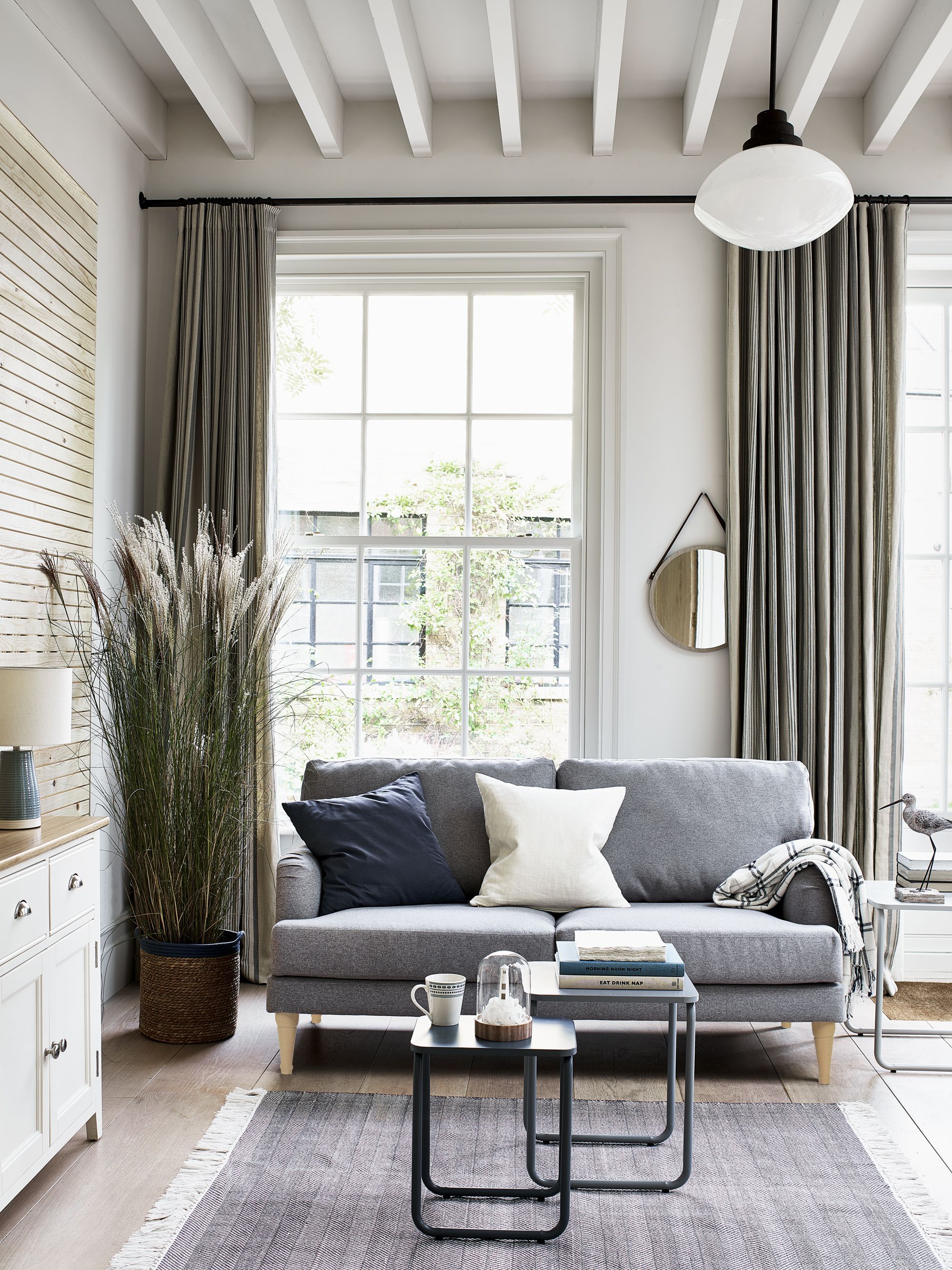 Grey living room with grey sofa and large grey rug