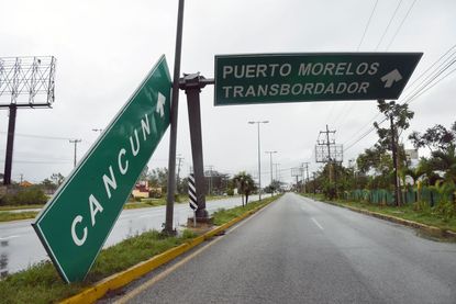 Hurricane Delta toppled signs in Cancun.