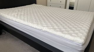 The Levitex mattress topper lying flat on the bed, after it's fully expanded