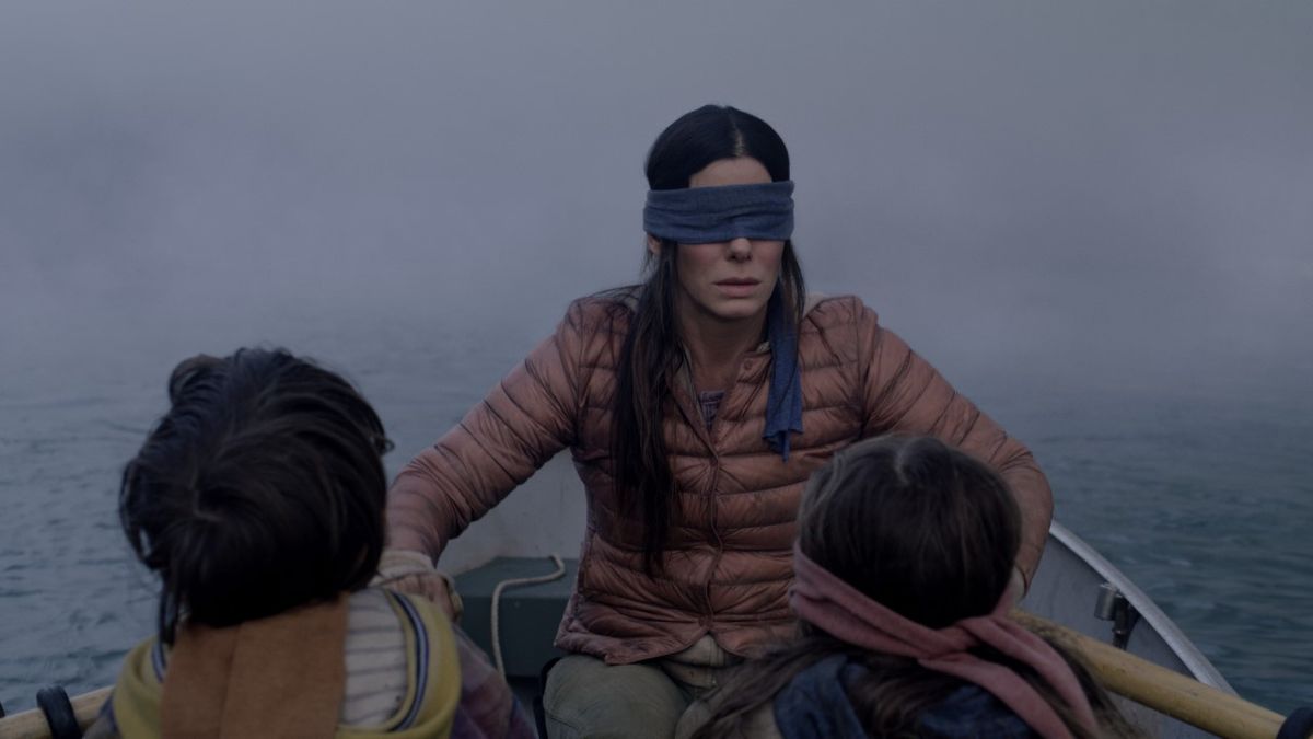 Sandra Bullock rows a boat blindfolded in Bird Box on Netflix.