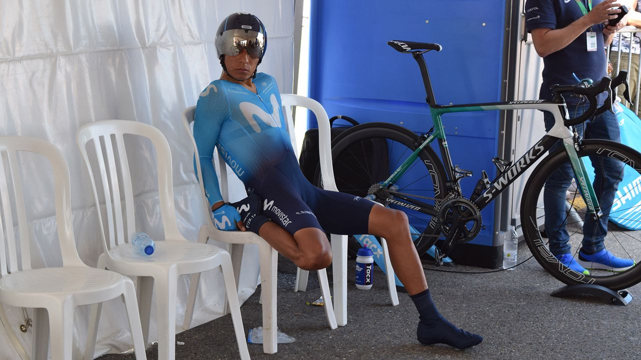Nairo Quintana stretches out his quadriceps while seated ahead of the start