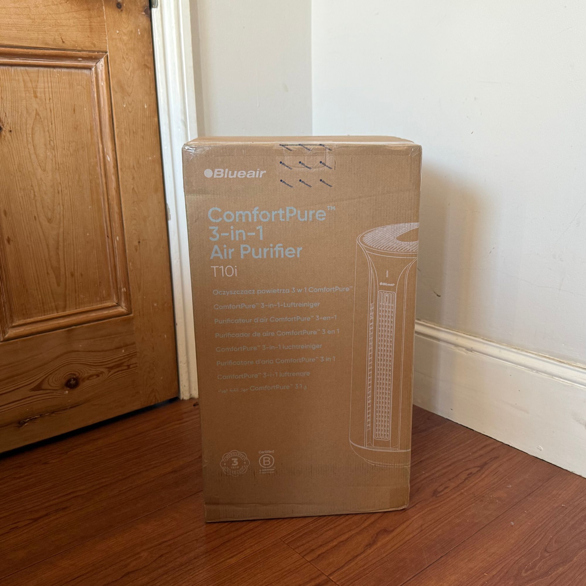 Blueair ComfortPure 3-in-1 T10i Air Purifier box standing on wooden floor