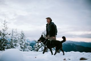 Man out walking dog in the snow