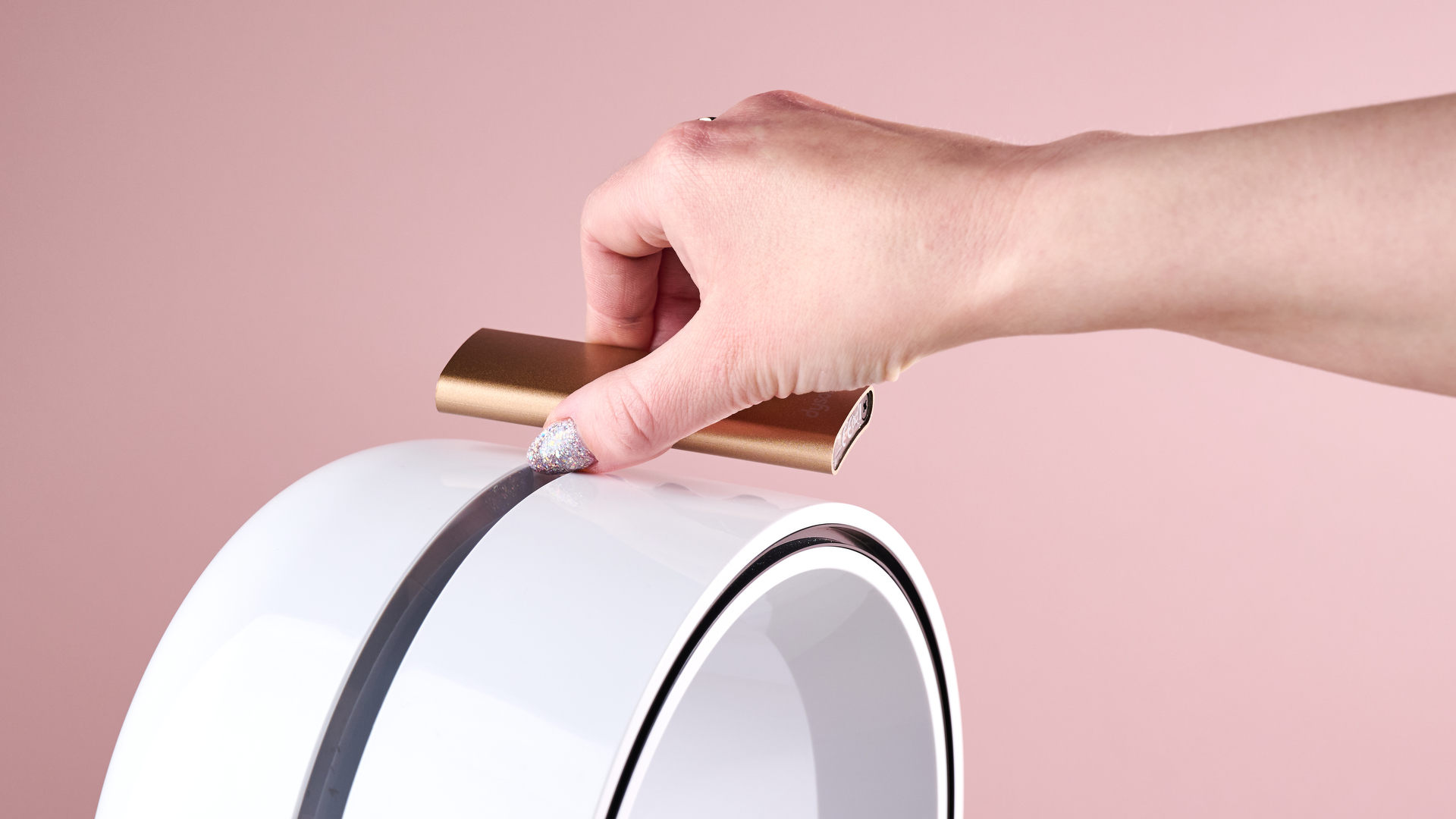 A woman is placing the remote on top of the loop amplifier.