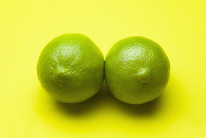 limes on a yellow background positioned to look like boobs