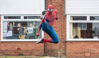 STOCKPORT, ENGLAND - APRIL 01: Jason Baird dressed as Spider-Man walks the streets of Bredbury to cheer-up children self isolating at home on April 01, 2020 in Stockport, United Kingdom. The Coronavirus (COVID-19) pandemic has spread to many countries across the world, claiming over 40,000 lives and infecting hundreds of thousands more. (Photo by Anthony Devlin/Getty Images)