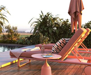 A backyard with pink outdoor furniture by a pool