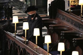 Queen Elizabeth II watches as pallbearers carry the coffin of Prince Philip, Duke Of Edinburgh into St George’s Chapel by the pallbearers during the funeral of Prince Philip, Duke of Edinburgh at Windsor Castle on April 17, 2021 in Windsor, United Kingdom